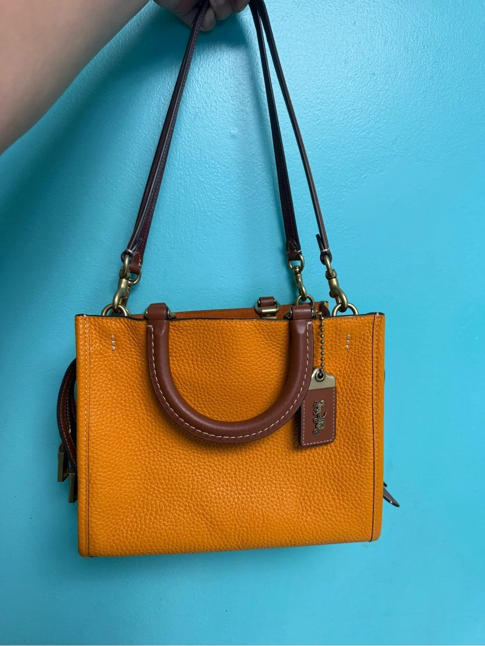 Coach Pebbled rouge 25 in papaya orange